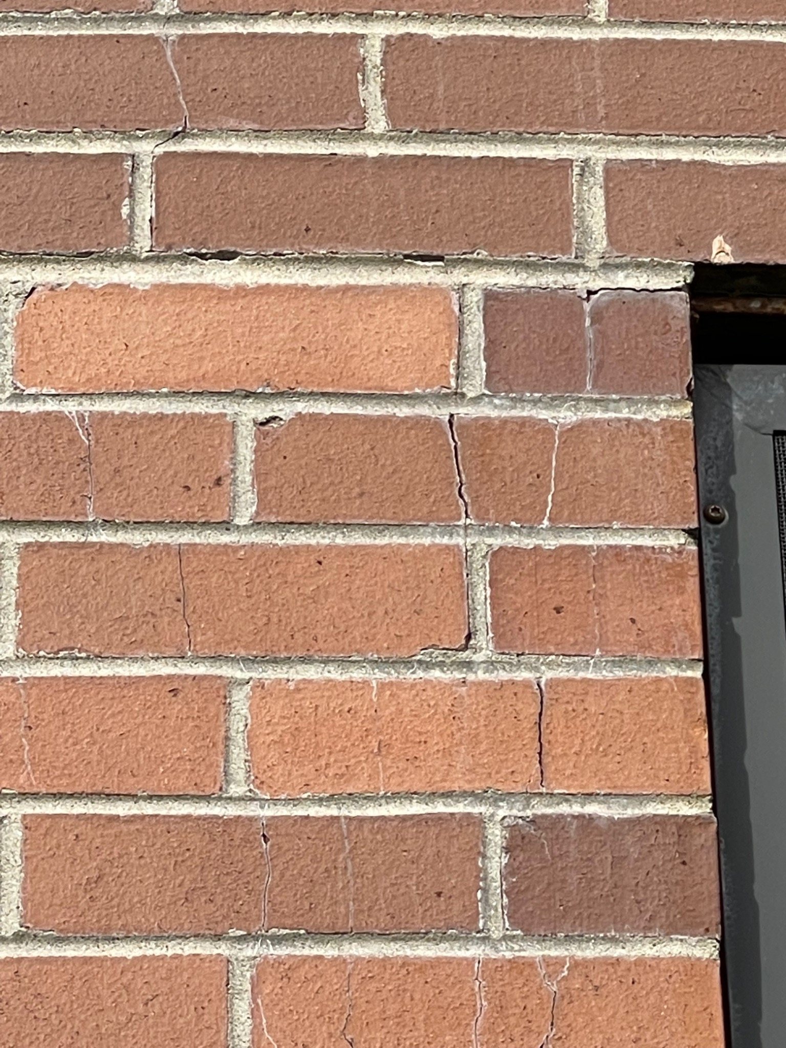 Cracked brick masonry adjacent to a window opening at the Charlottetown armoury