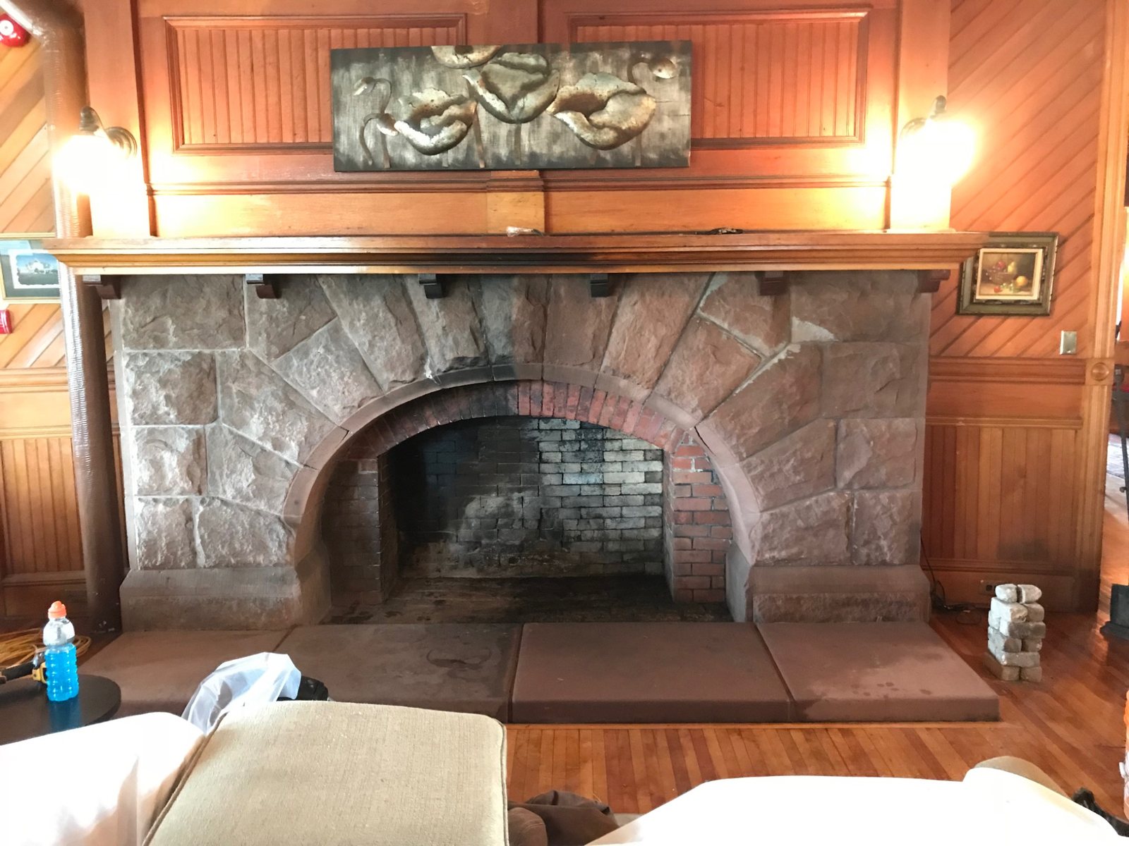 Historic fireplace at Dalvay by the Sea with half of the masonry cleaned to show soot removal contrast