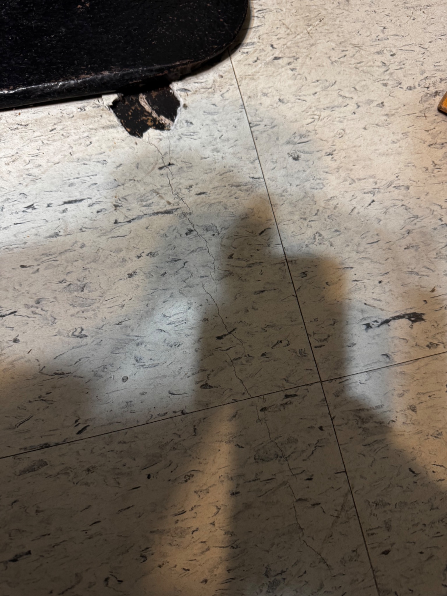 Localized floor damage near the base of a chimney after a lightning strike