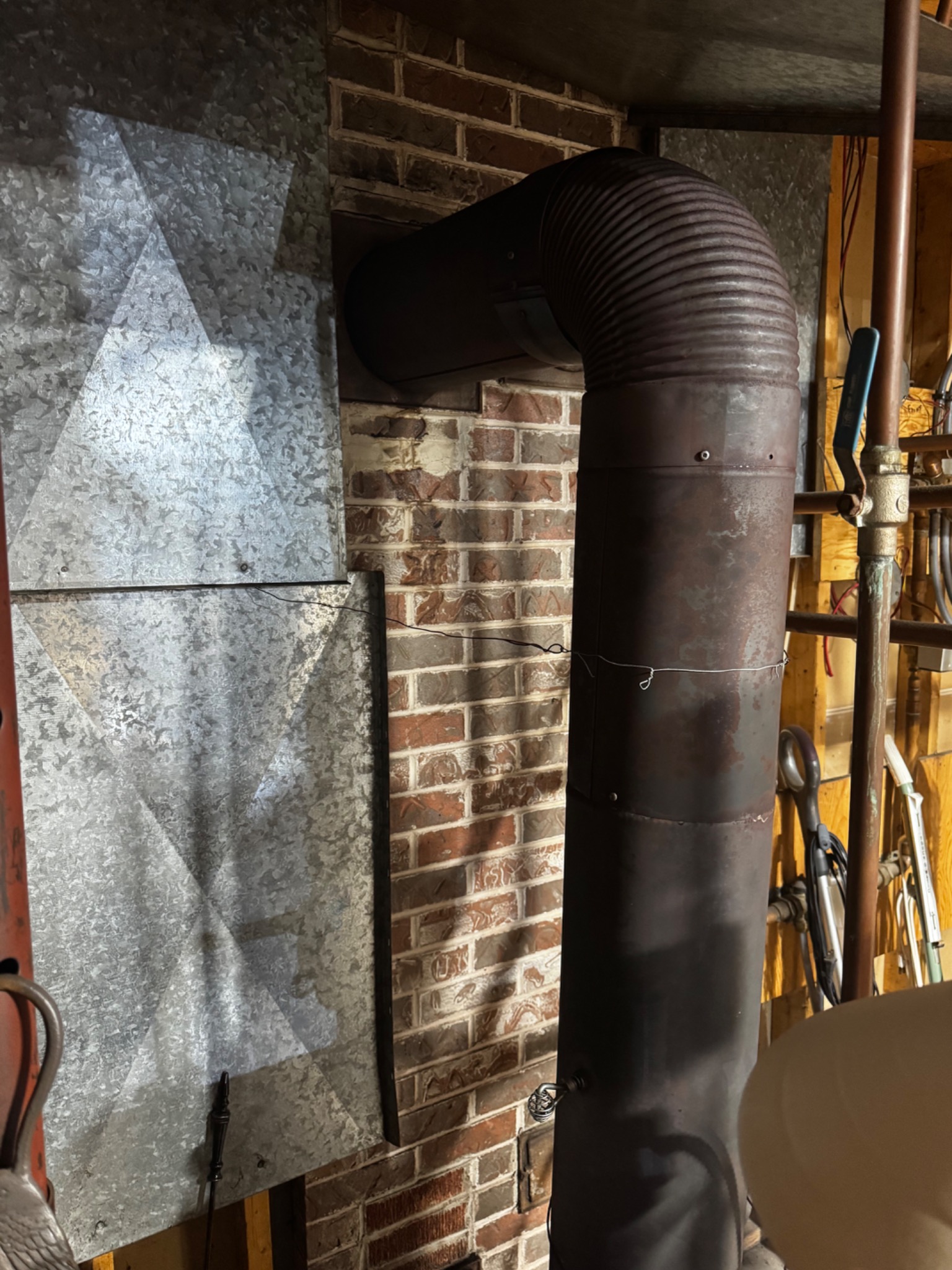 Metal chimney liner and masonry chimney in a basement during a post-lightning inspection
