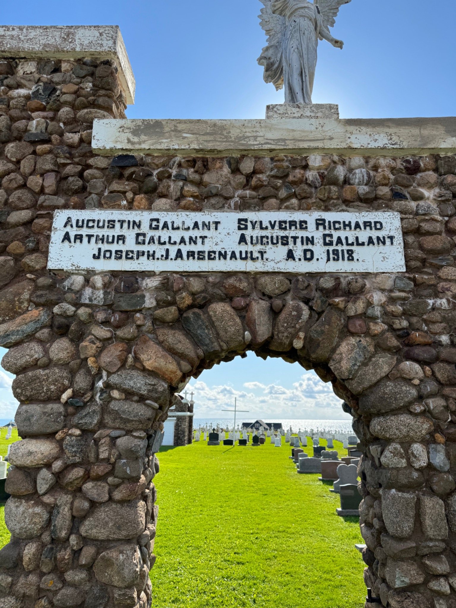Mont-Carmel stone cenotaph and war memorial arch at Notre-Dame-du-Mont-Carmel Church in Prince Edward Island