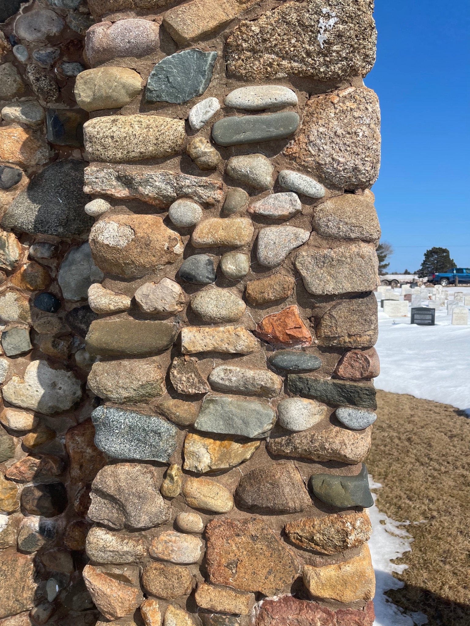 Original fieldstone masonry with weathered and missing mortar joints at a Mont-Carmel monument