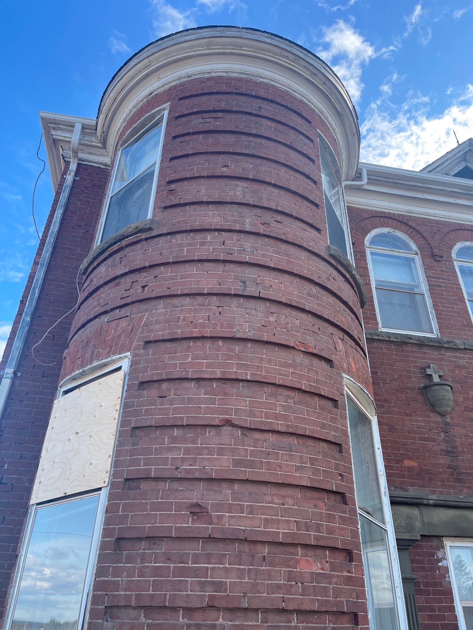 Curved historic brick tower masonry at the Mont-Carmel Parish House