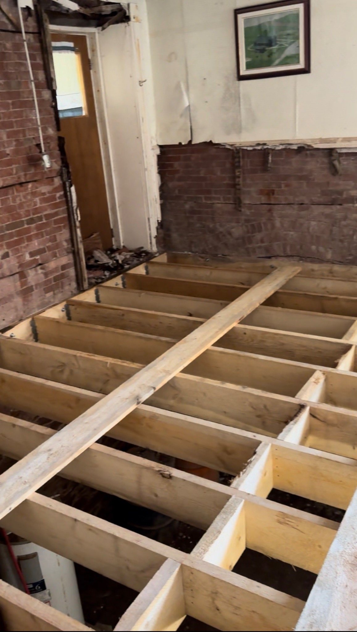 New floor framing being installed inside the historic Mont-Carmel Parish House