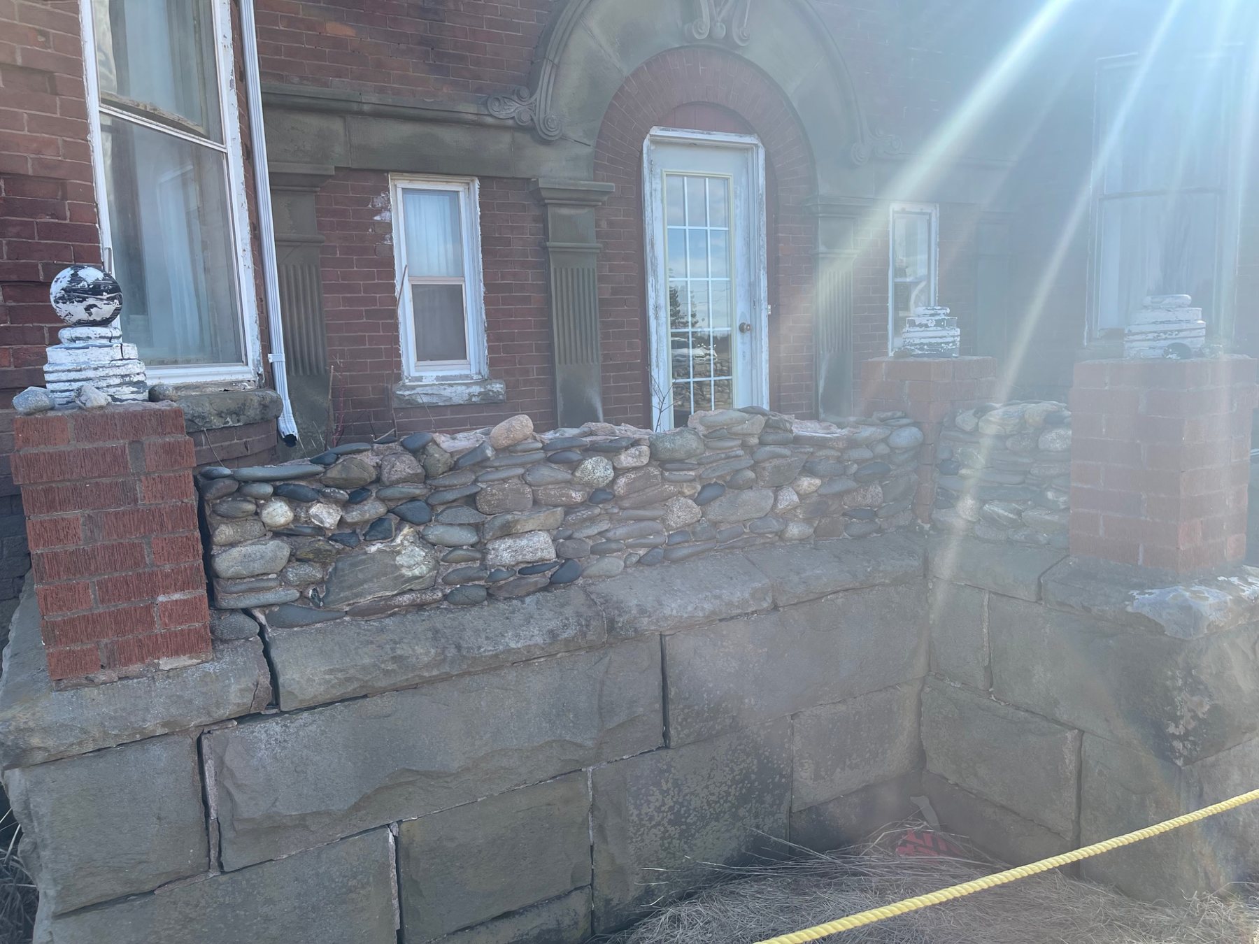 Historic stone foundation and brick wall transition at the Mont-Carmel Parish House