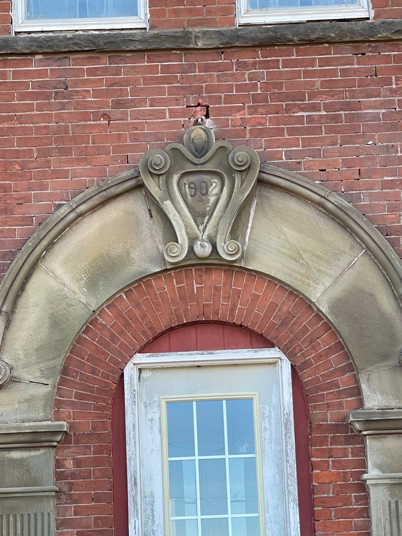 Carved stone and brick entrance detail at the Mont-Carmel Parish House