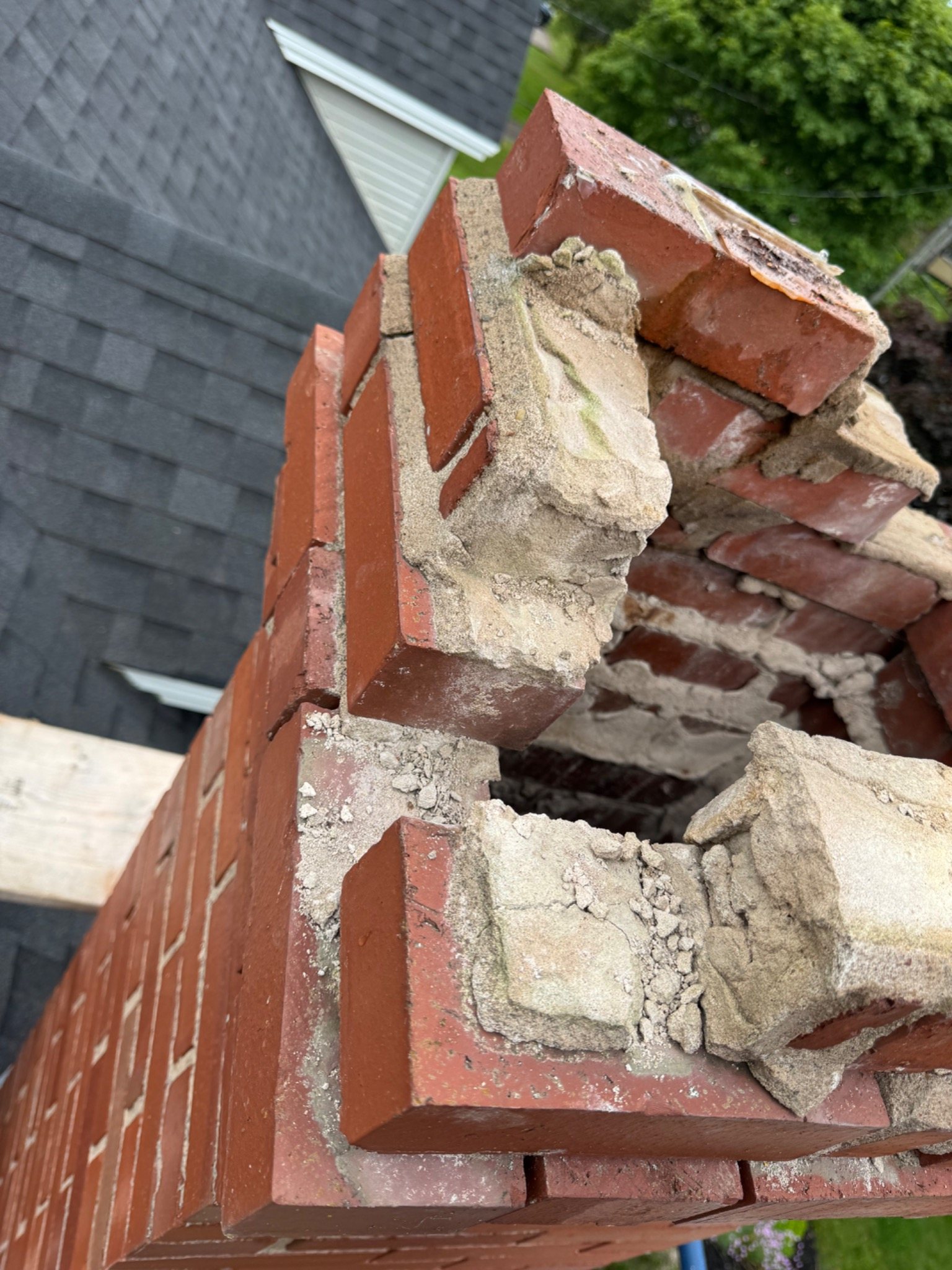 Deteriorated chimney upper courses opened during dismantling