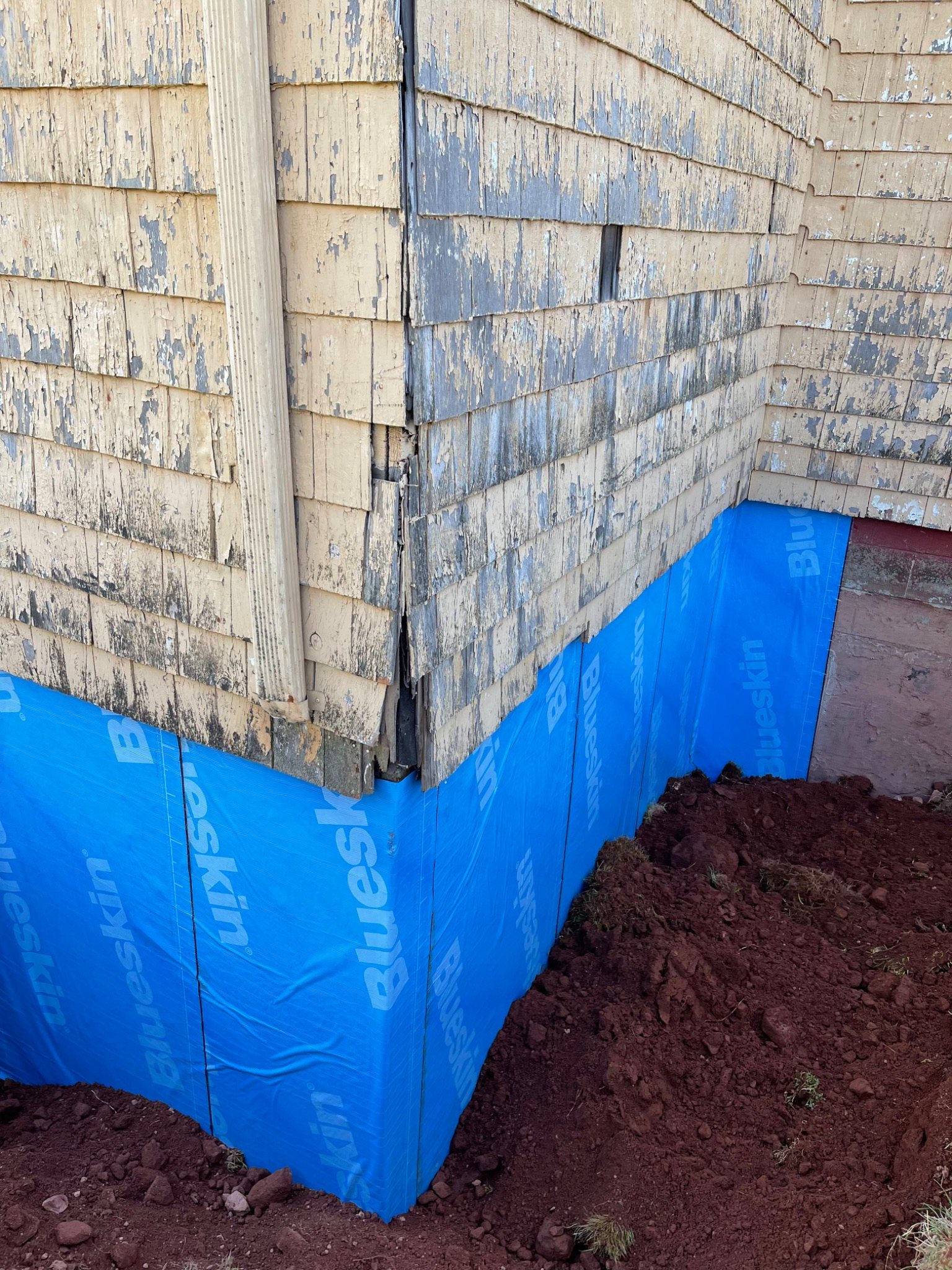 Exterior waterproofing membrane installed over a repaired church foundation