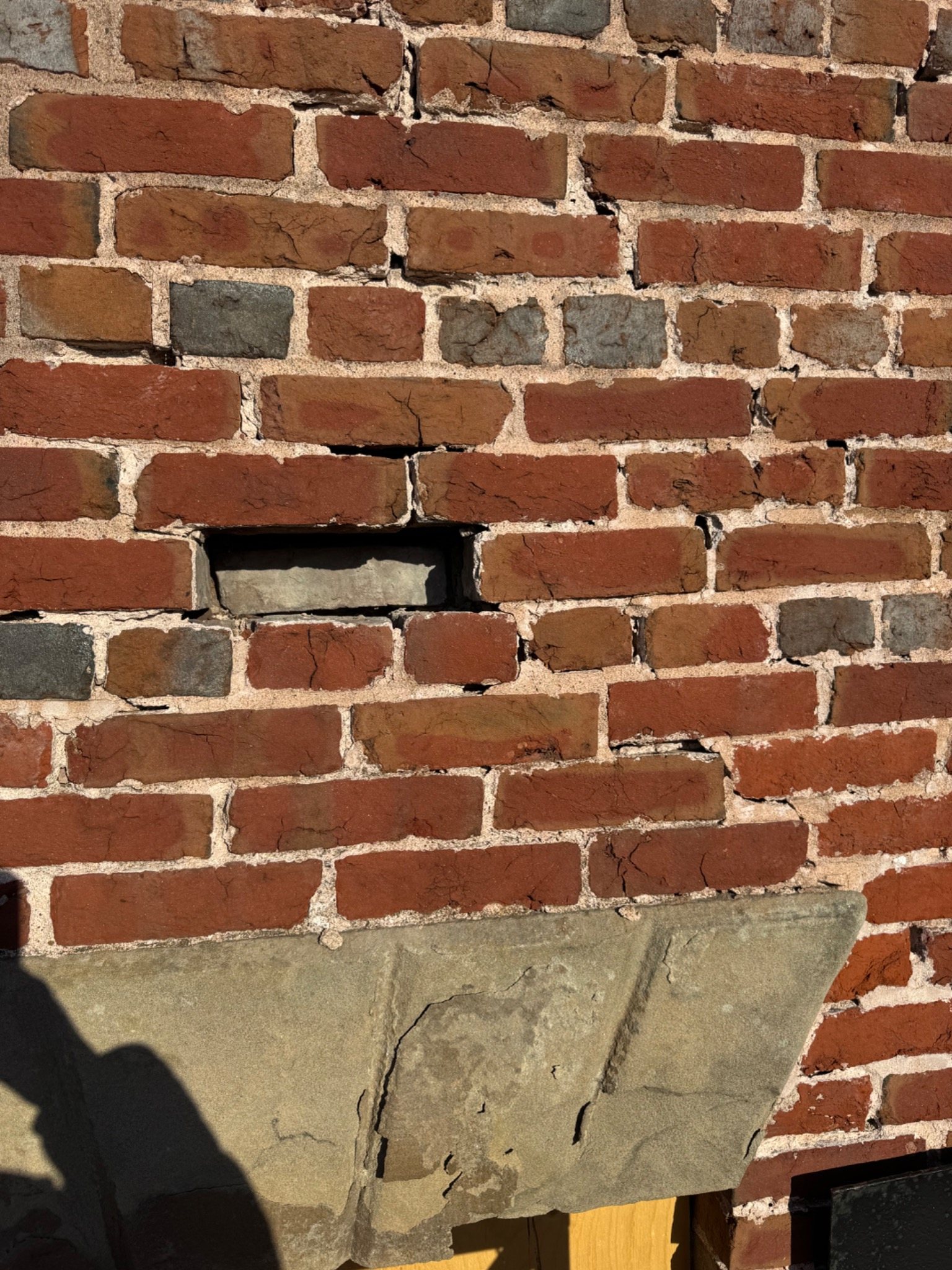 Historic brick wall with deep open mortar joints and deteriorated masonry