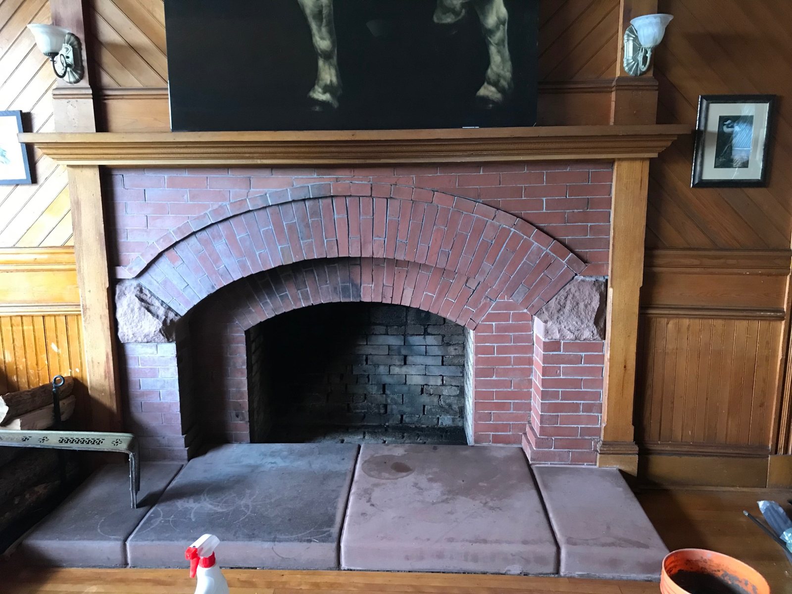 Large brick arch fireplace with open masonry firebox