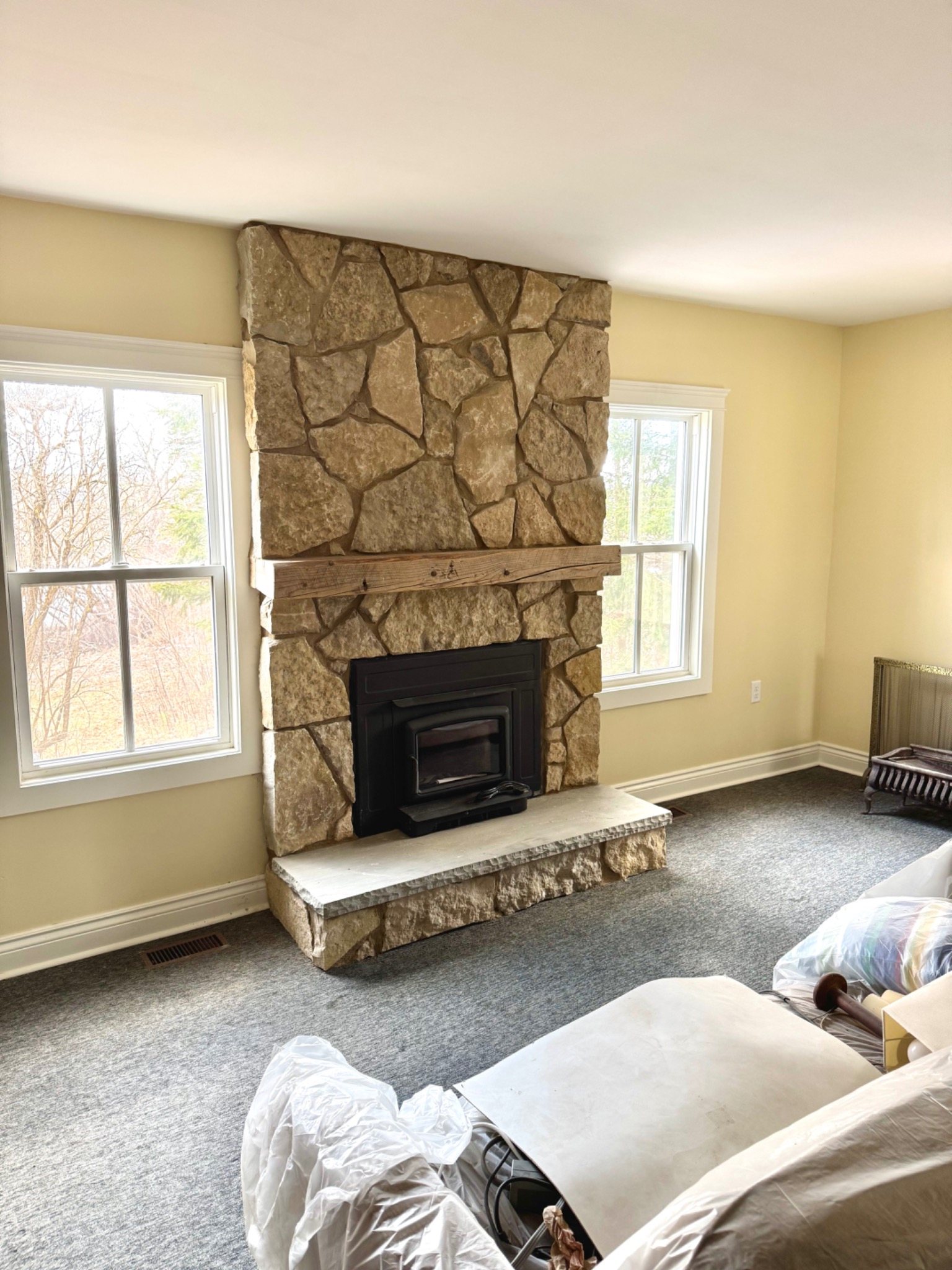 Natural stone fireplace surround with a solid-fuel insert