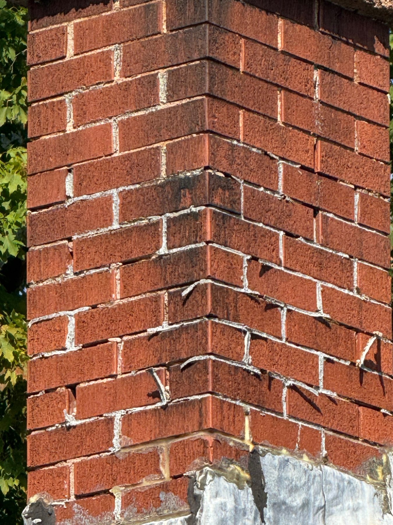 Displaced brick courses and open mortar joints on a PEI chimney