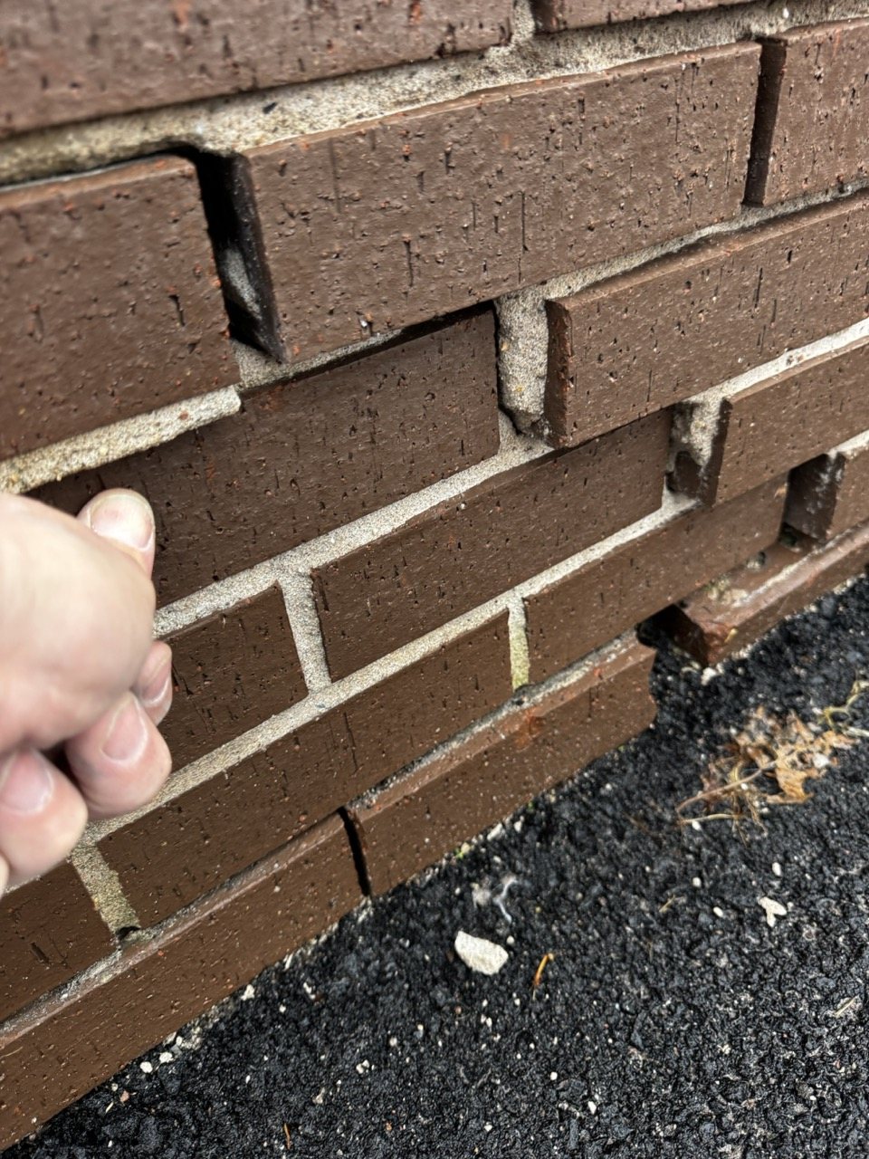 Loose brick and open mortar joints in a masonry wall in Prince Edward Island