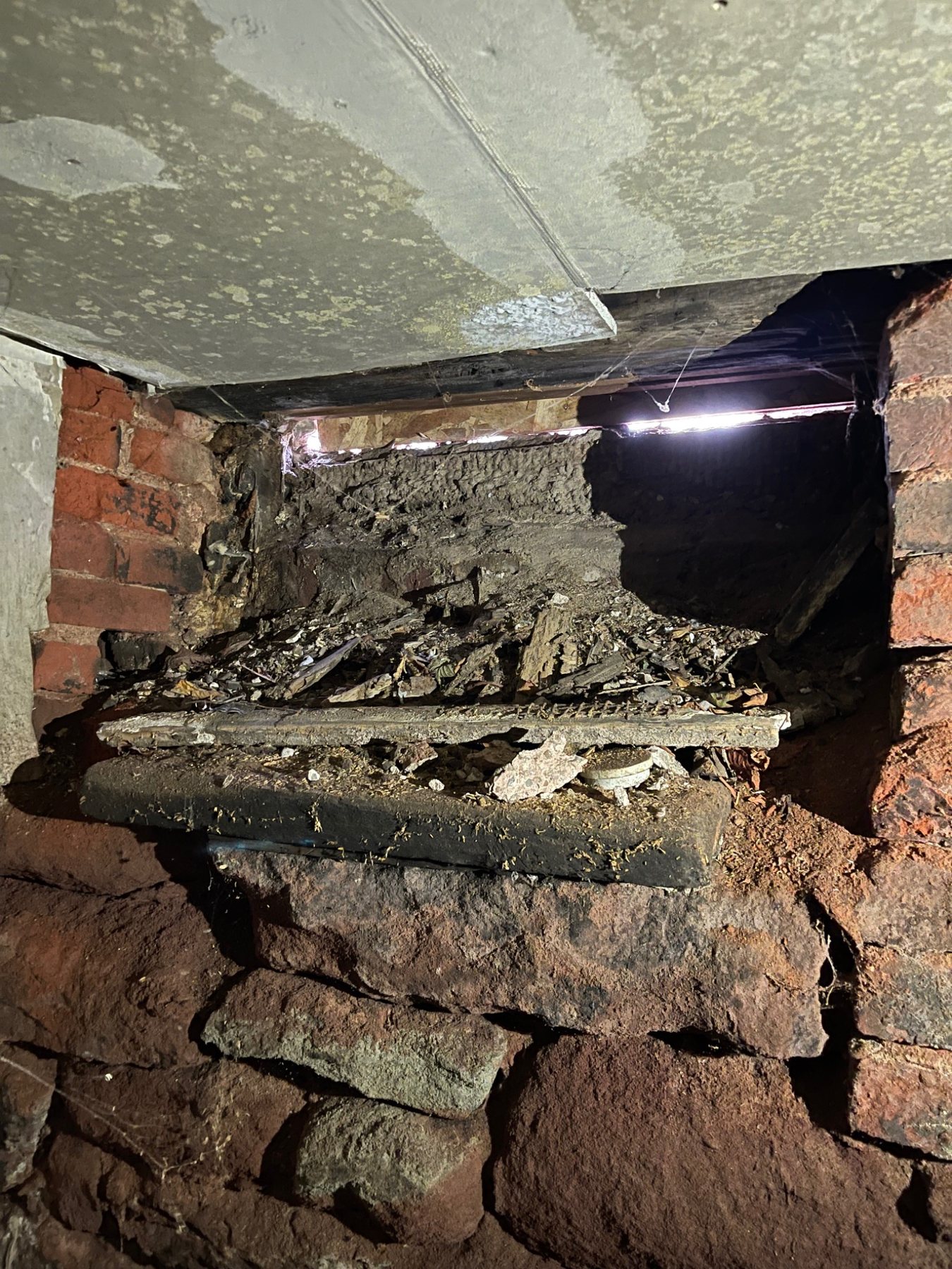 Opened interior masonry showing deep voids and irregular stonework behind the visible wall face