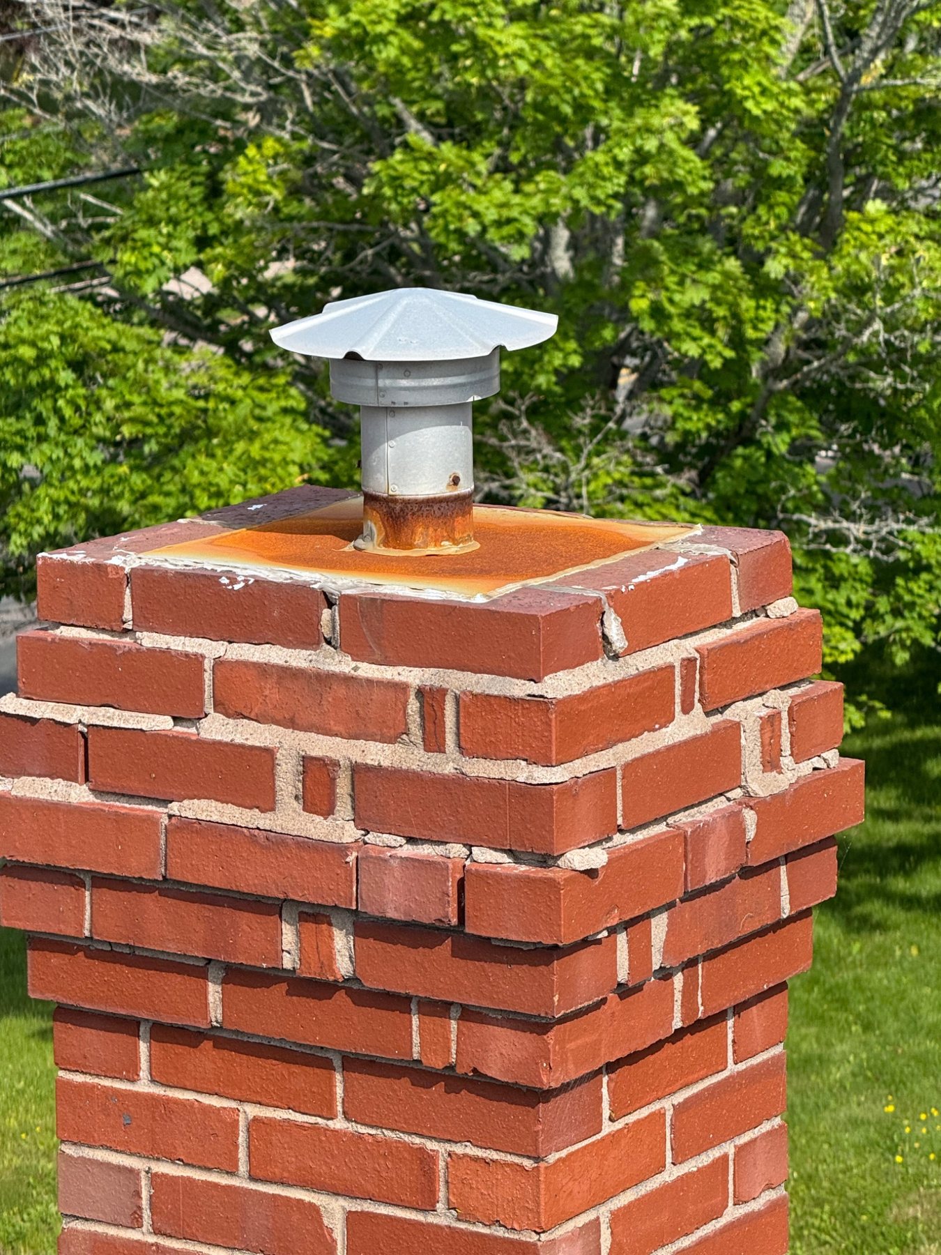 Cracked and deteriorated chimney top with open mortar joints in Prince Edward Island