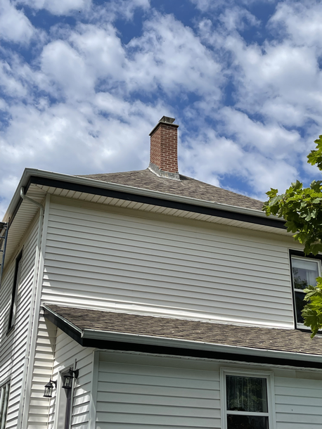 An image of a red brick chimney with lead flashing